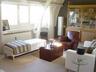 Living area with woodburning FIREPLACE and large window on t