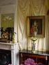 Fine antiques and silk wall draperies making it opulant and