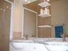 The bathroom with twin marble vanitory unit, bath & overhead shower attachment