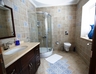 Ground floor bedroom en suite with shower cabin,  WC and handbasin 