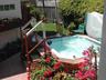 Bubbing hot tub with small croquet lawn & fountain