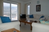 Sitting room with Patio  doors opening onto a sea view terra