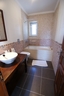 Double bedroom en suite bathroom with bath, WC and handbasin
