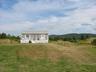 front view of cottage, highlands in the background