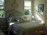 Guest room with White wicker double bed and single day bed