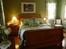 Queen guest room with sleigh bed, antique furnishings and ensuite bath