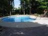 Heated kidney shaped pool in private treed lot with dining a